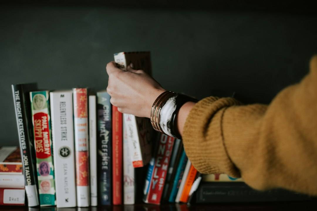 An adult reading in a library, representing curiosity and lifelong learning